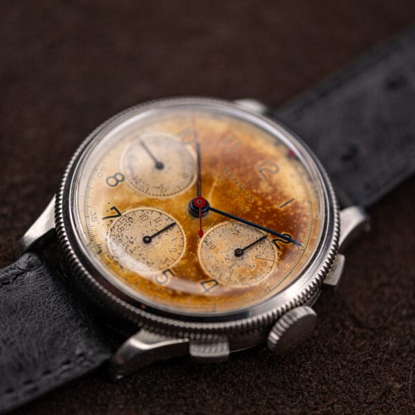 Benrus Sky Chief dial in raking light showing caramel colour drift across the silvered base