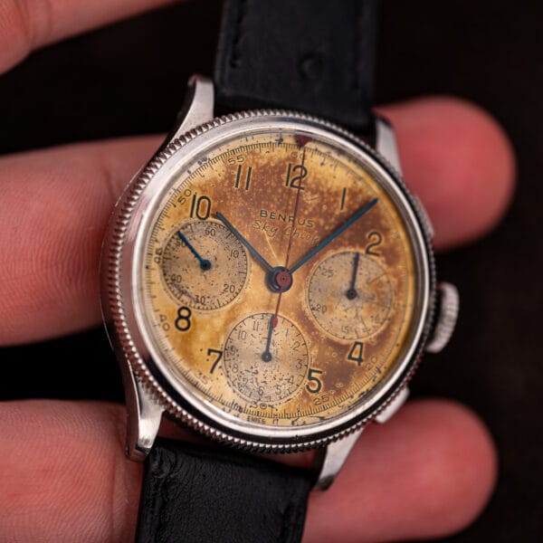Vintage Benrus Sky Chief chronograph held in hand showing 37.5mm case scale and milled bezel