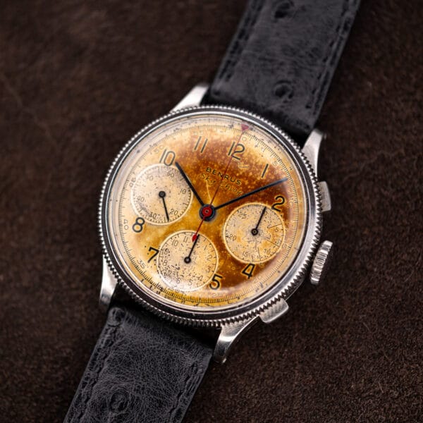Benrus Sky Chief steel chronograph three-quarter view, blued hands over a champagne dial edge