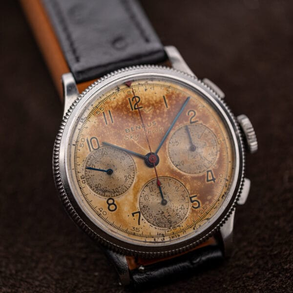 Benrus Sky Chief pilot chronograph on black ostrich strap showing the red triangle bezel marker