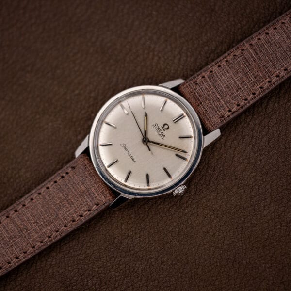 Vintage Omega Seamaster 165.002 automatic angled on its brown Babele leather strap, domed acrylic crystal