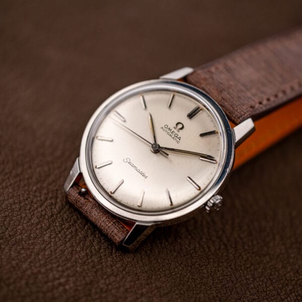 Vintage Omega Seamaster 165.002 on brown leather strap with orange lining, crown at three