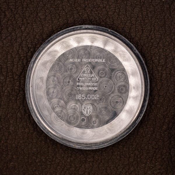 Omega 165.002 inner caseback stamped ACIER INOXYDABLE, FAB. SUISSE and the reference 165.002