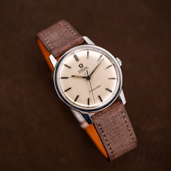 Vintage Omega Seamaster 165.002 angled view, doubled baton marker at twelve and sweep seconds hand
