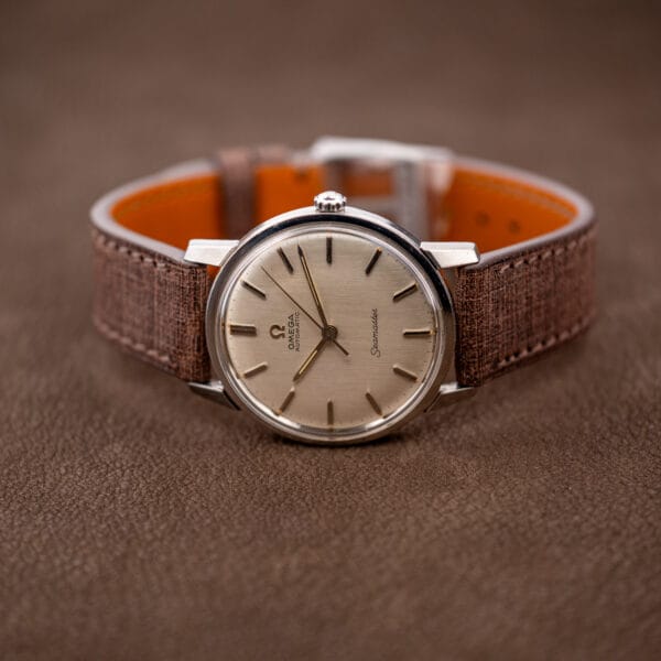 Omega Seamaster 165.002 upright on brown leather strap with steel buckle and orange lining