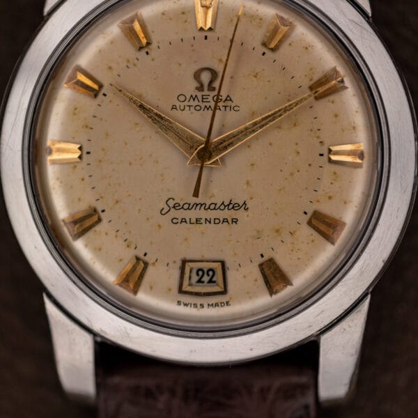 Omega Seamaster Calendar dial macro showing freckled eggshell patina, Seamaster script and CALENDAR text