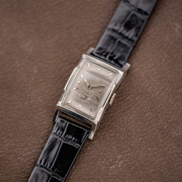 Vintage Gruen Curvex Precision 370-650 rectangular watch angled on brown leather with black alligator grain strap extended