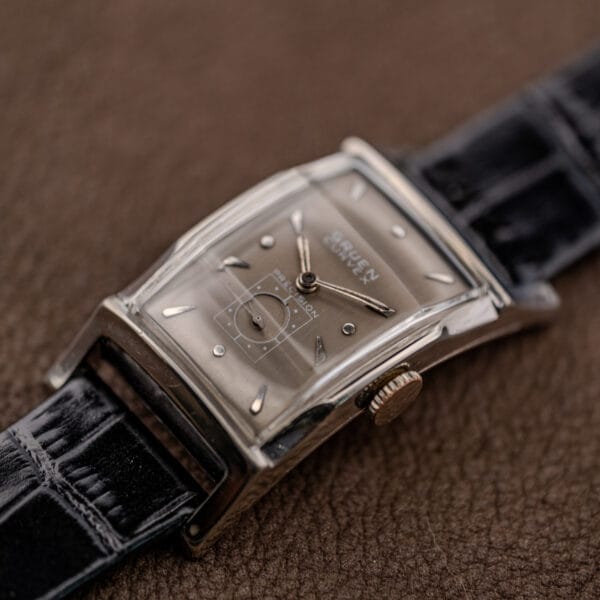 Gruen Curvex 370-650 stepped white gold filled case corner and fluted crown beside the PRECISION seconds register
