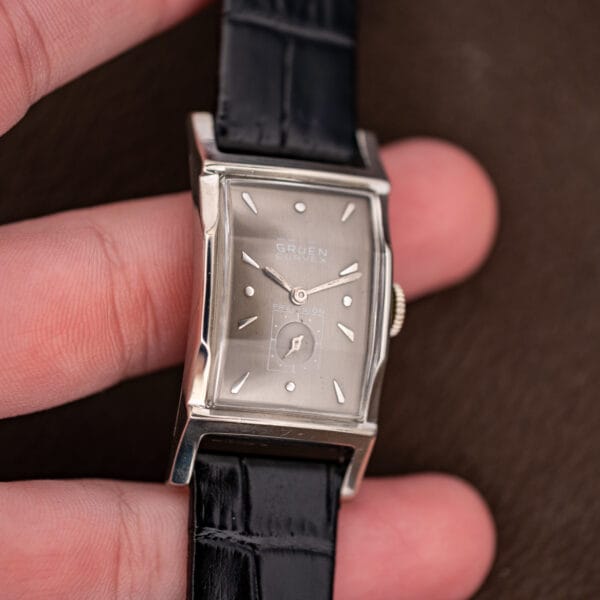 Vintage Gruen Curvex Precision 370-650 held in hand showing compact rectangular proportions and applied dial markers