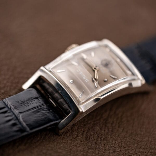 Low angle view of the Gruen Curvex Precision curved case with applied dial markers catching the light