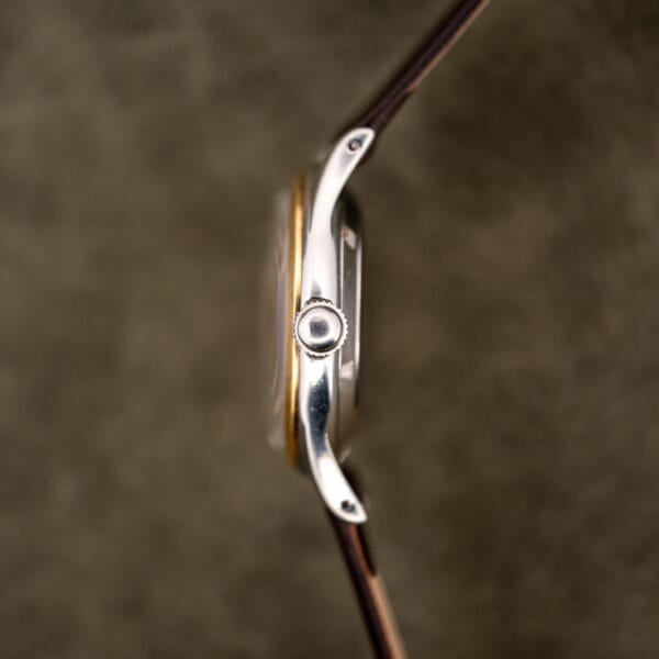 Side profile of the Baylor Automatic stainless case with the crown at three and the bezel edge in view