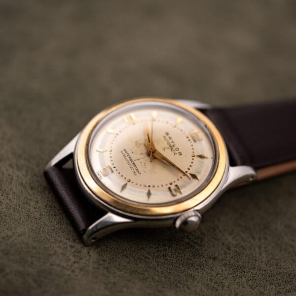 Baylor Automatic three quarter view with the domed acrylic crystal catching light across the cream dial