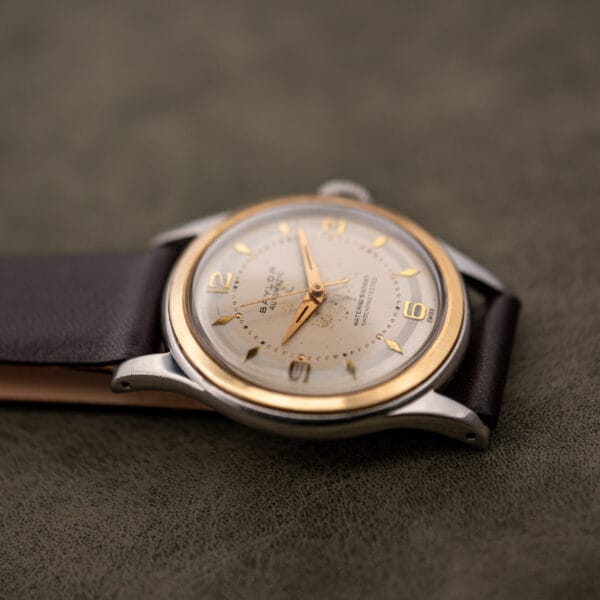 Low angle of the Baylor Automatic showing bezel depth, polished steel case flank and fluted crown