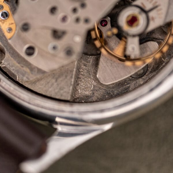 Close view of the AS shield logo and calibre 1361 stamped on the movement bridge beside the balance wheel