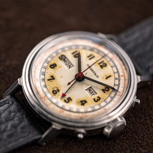 Angled view of the Movado 14819 showing domed crystal, day window at nine and month window at three