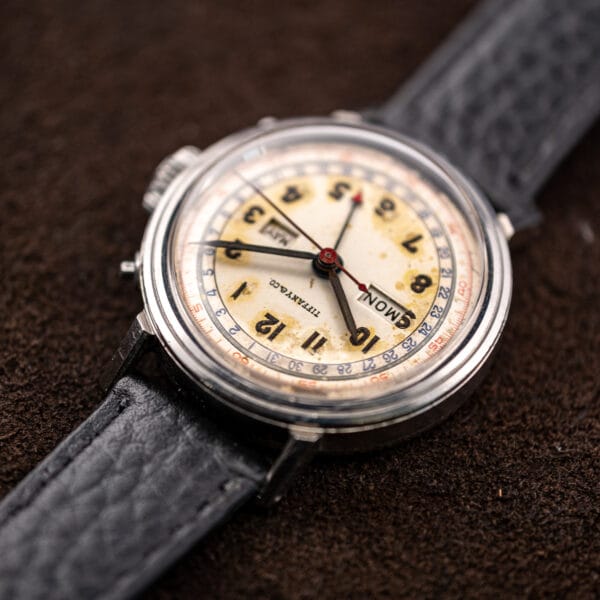 Movado 14819 viewed from the six o'clock side, calendar windows and Tiffany & Co. dial signature in raking light