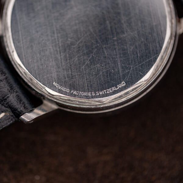Macro of the MOVADO FACTORIES SWITZERLAND stamping curving along the lower edge of the 14819 caseback