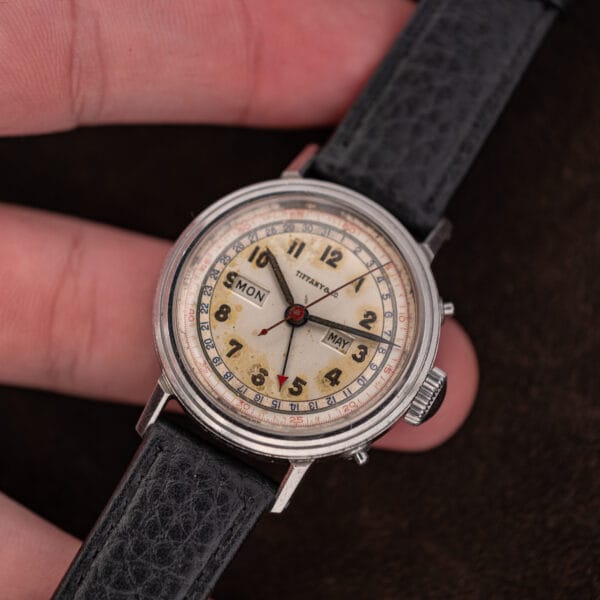Movado triple calendar 14819 held in hand, showing its 33mm proportions and Tiffany & Co. signed dial