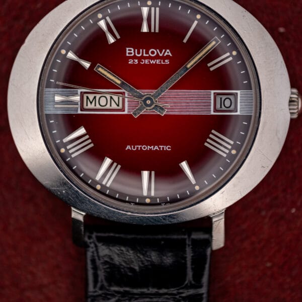 Bulova President C maroon dial with applied silver Roman numerals and the white zone from 3 to 9