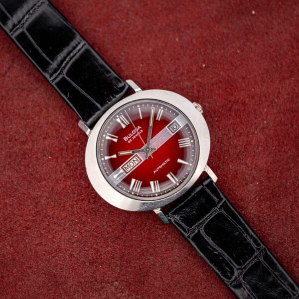 Bulova T-3092 automatic with strap extended, fluted crown at three and the wide sloping steel bezel