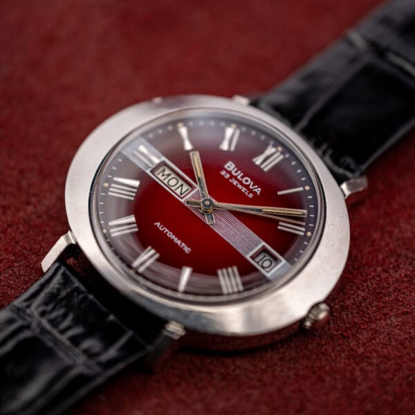 Low angle on the Bulova saucer case showing its shallow disc profile and short faceted lugs