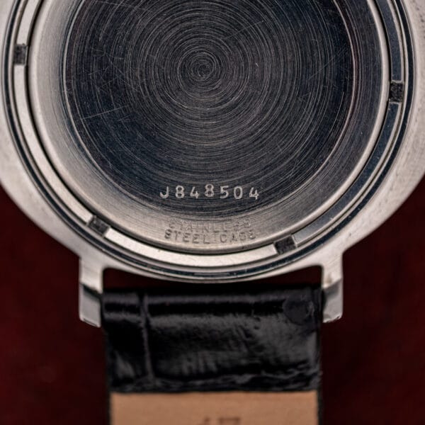 Macro of the Bulova caseback serial J848504 above the STAINLESS STEEL CASE stamping and lower lug