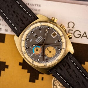 Omega Seamaster 176.007 gold plated chronograph angled on its original Omega guarantee papers, mocha dial and date window