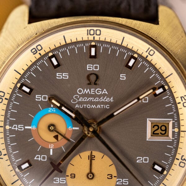 Macro of the 176.007 mocha sunburst dial showing the Omega Seamaster Automatic signature and faceted date aperture at three