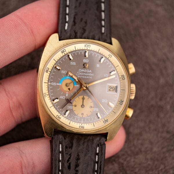 Omega Seamaster 176.007 held in hand, showing cushion case proportions against the fingers