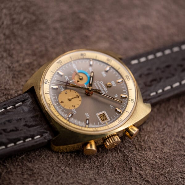 Low angle detail of the 176.007 with gold pushers and crown sharp and the mocha dial falling soft