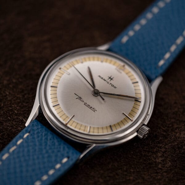 Vintage Hamilton Thin-O-Matic watch three-quarter view with applied steel batons and aged rust-orange lume
