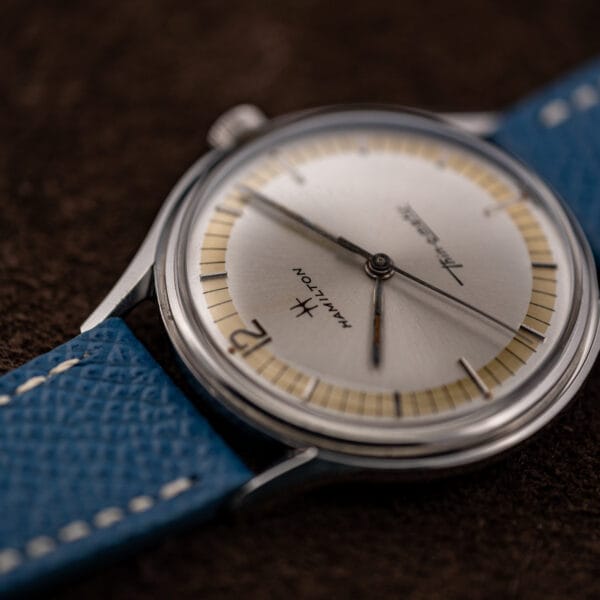 Close view of the Hamilton cal. 663 dial, aged lume in the hands and combed champagne minute track