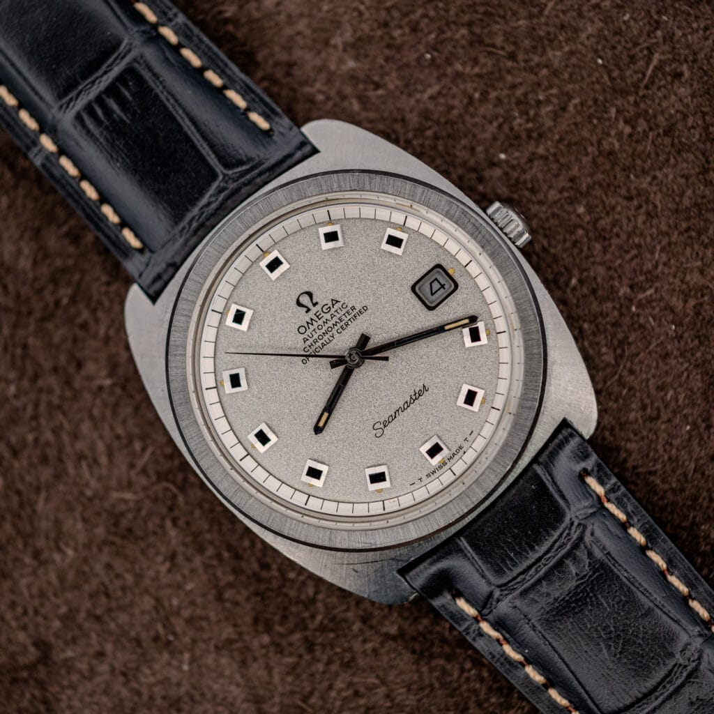 Omega Seamaster 168.035 Jumbo angled view with frosted silver dial, black square markers, and black leather strap