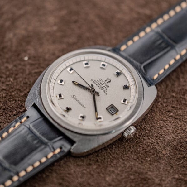 Omega Seamaster 168.035 oblique dial view highlighting the granular silver finish and framed date