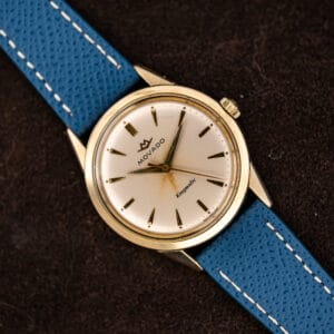 Vintage Movado Kingmatic automatic on a blue leather strap, white dial with applied gold markers