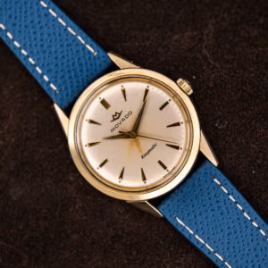 Vintage Movado Kingmatic automatic on a blue leather strap, white dial with applied gold markers