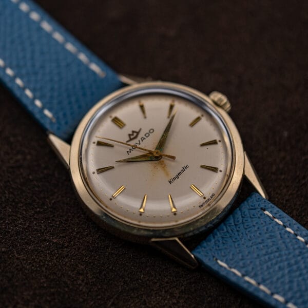Movado Kingmatic angled to show Switzerland printed at six and the fluted signed crown