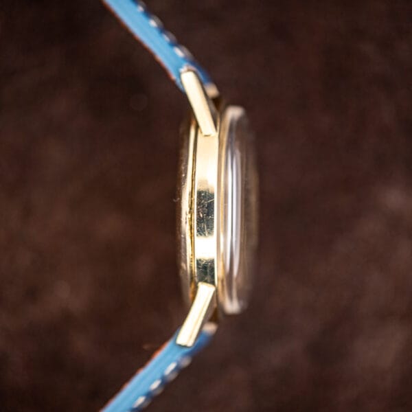 Side profile of the Kingmatic case showing the thin bezel, domed crystal and honest wear