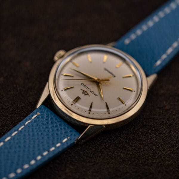 The Kingmatic viewed from the six o'clock side, gold markers catching light across the dial