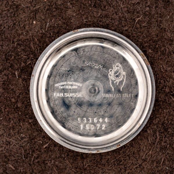 Movado inner caseback stamped MOVADO FACTORIES SWITZERLAND, FAB SUISSE, reference 15072 and case 533644 among scratched service marks