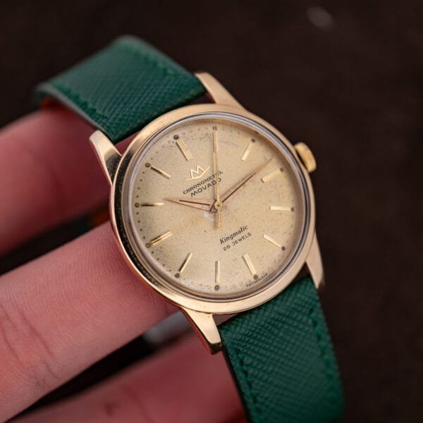 Vintage Movado Kingmatic held in hand showing 34mm case scale and the doubled batons at three and nine
