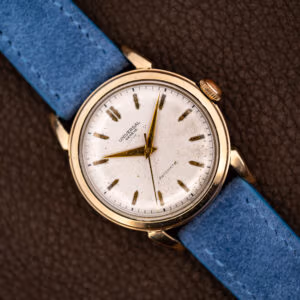 Universal Genève automatic with a white dial and gold dauphine hands on a powder blue suede strap
