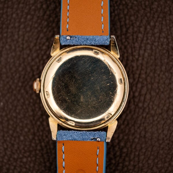 Caseback of the Universal Genève showing fine surface scratches earned over decades of wear