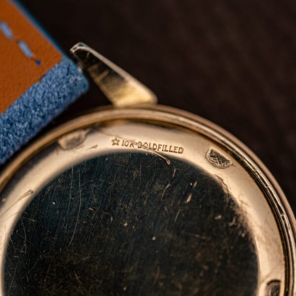 Macro of the caseback stamping reading 10K GOLDFILLED beside a small five pointed star