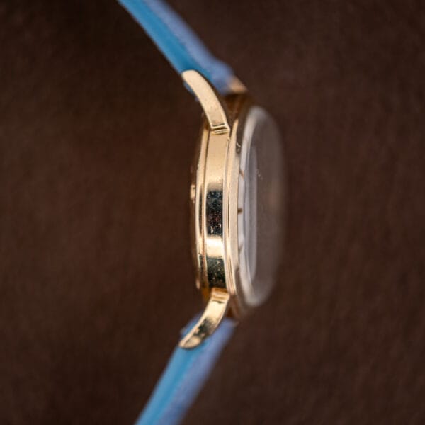 Case profile from the opposite side, the domed crystal rising well above the bezel