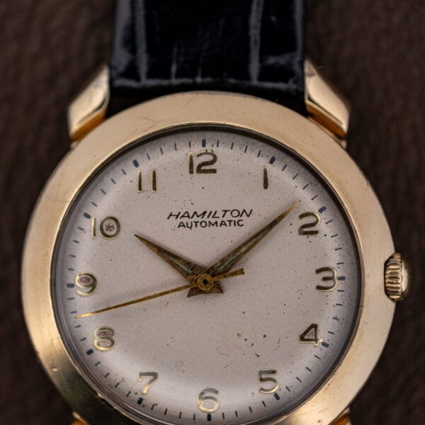 Close-up of the Hamilton K-455 dial showing applied gold numerals and aged luminous plots