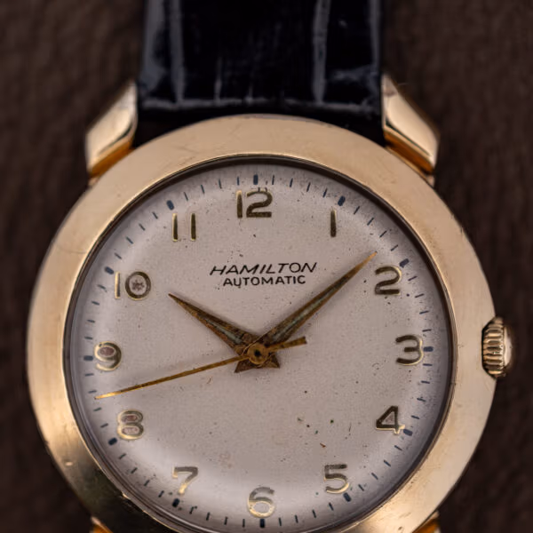 Close-up of the Hamilton K-455 dial showing applied gold numerals and aged luminous plots