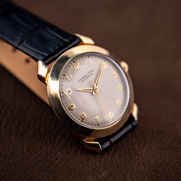 Angled view of the Hamilton K-455 showing honest wear across the gold filled case