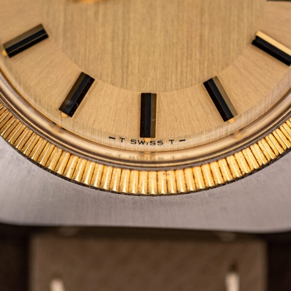 Dial macro with tritium T Swiss T marking at six o'clock on the Longines Electronic