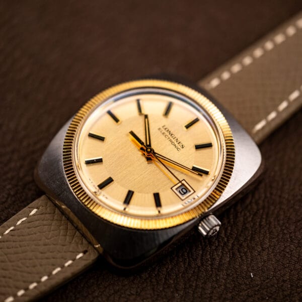 Three-quarter view of the Longines Electronic catching light across the champagne dial